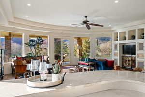 Living room featuring a ceiling fan, wood finished floors, and recessed lighting