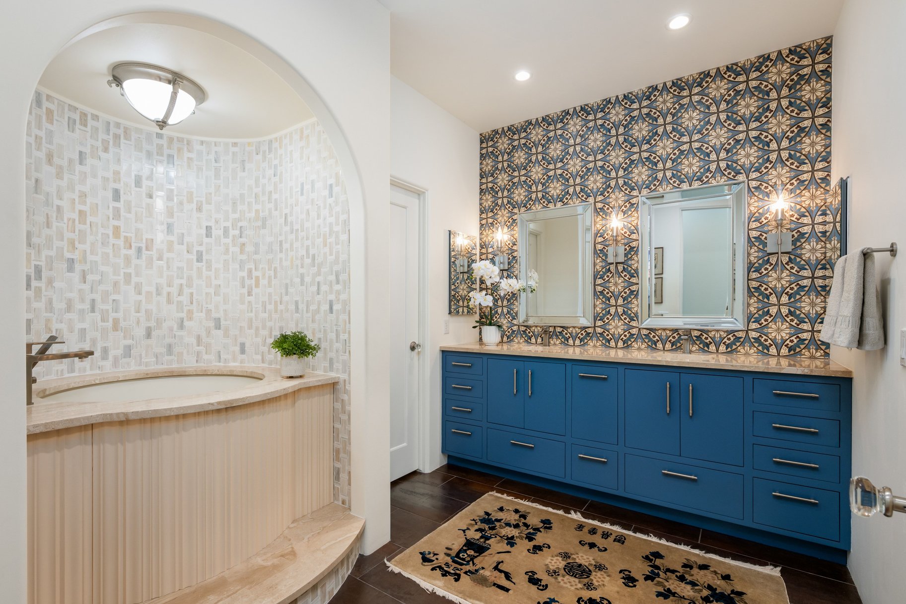 Bathroom with double vanity, dark wood-style floors, and recessed lighting