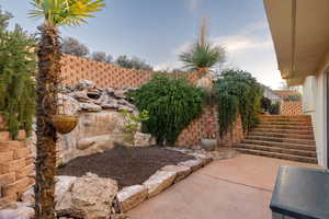 View of yard with a patio and stairs