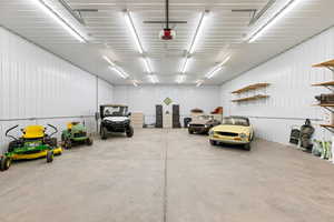 Garage featuring metal wall and a garage door opener