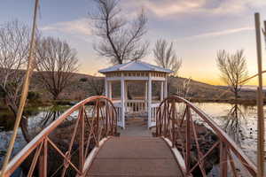 Dock with a gazebo and a water and mountain view