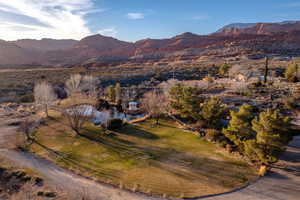 Aerial view of property's location featuring a mountain backdrop and rural landscape