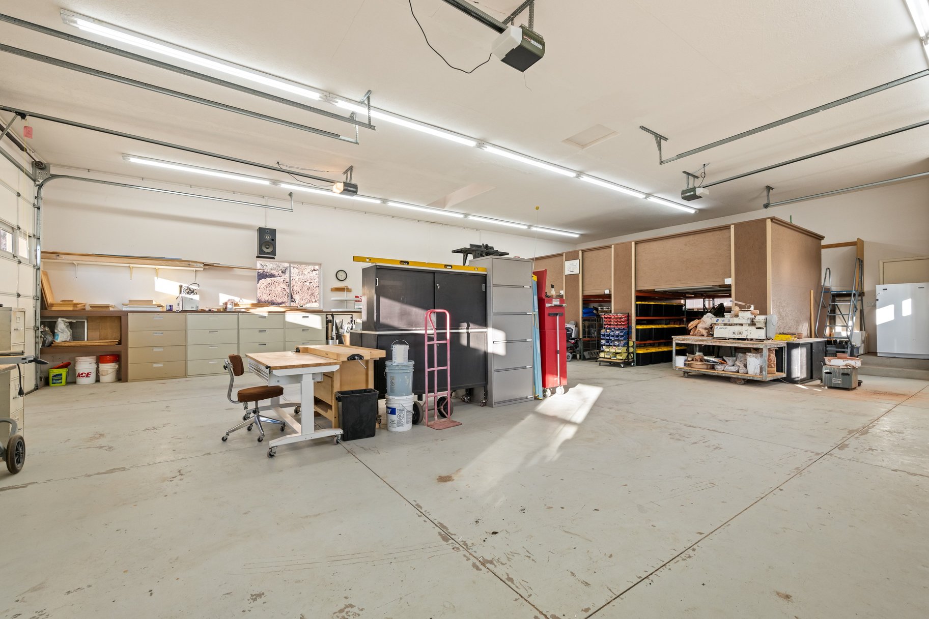 Garage featuring white fridge and a garage door opener
