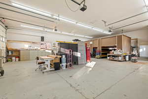 Garage featuring white fridge and a garage door opener