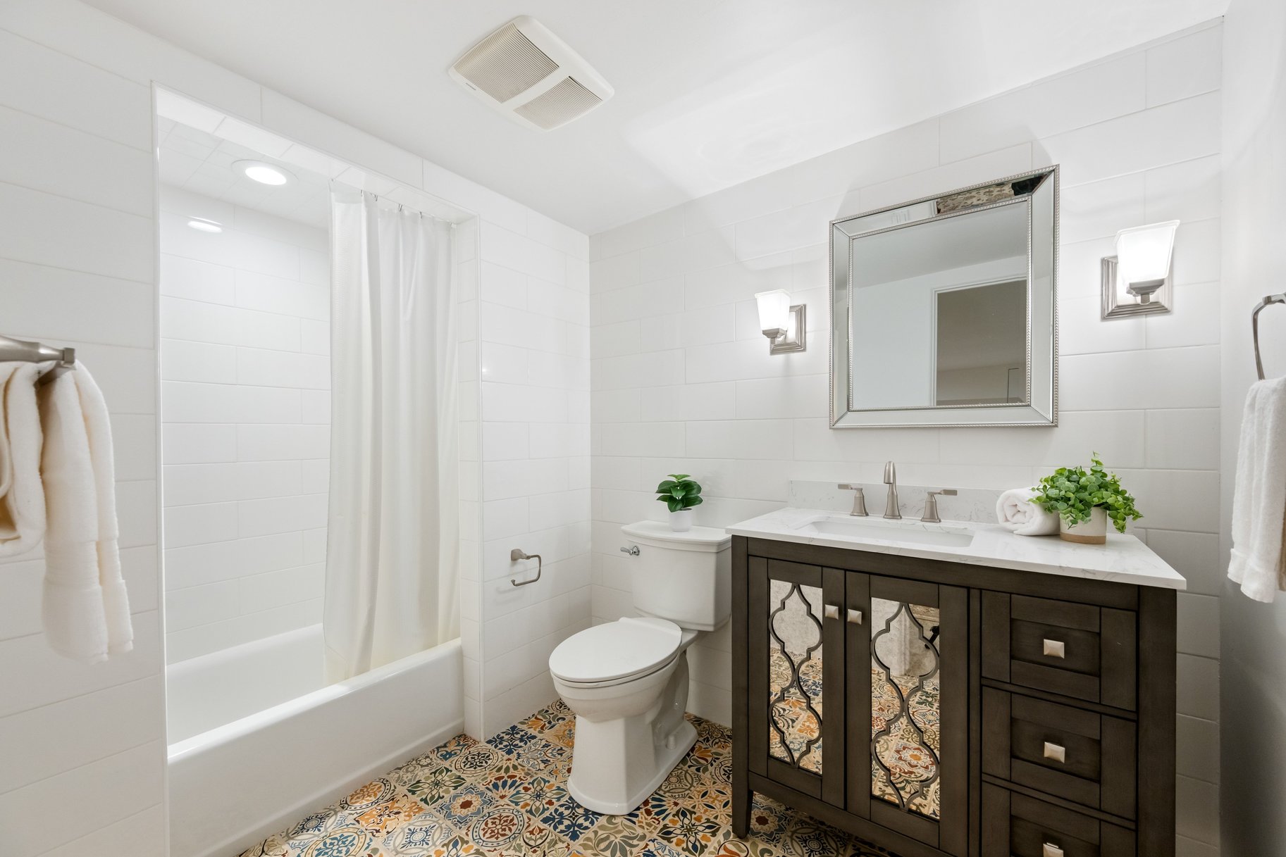 Full bath featuring shower / bath combo with shower curtain, vanity, tile walls, and tile patterned flooring
