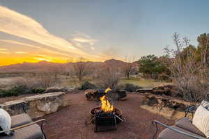 View of patio / terrace with an outdoor fire pit and a mountain view