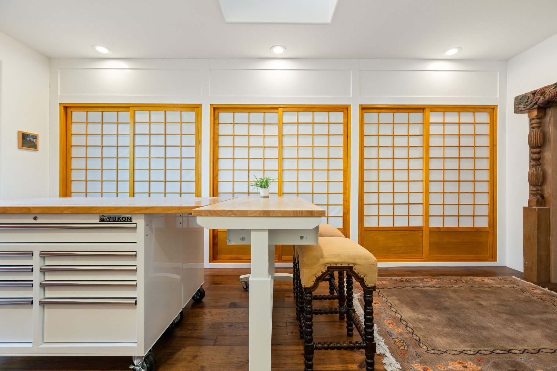 Dining room with dark wood-type flooring, recessed lighting, and a skylight
