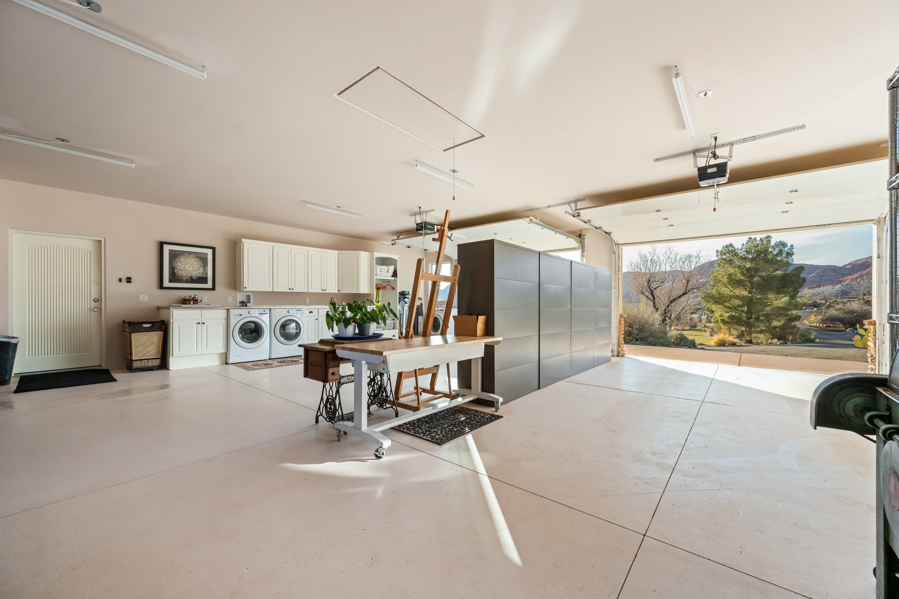 Garage with washer and dryer, a mountain view, and a garage door opener