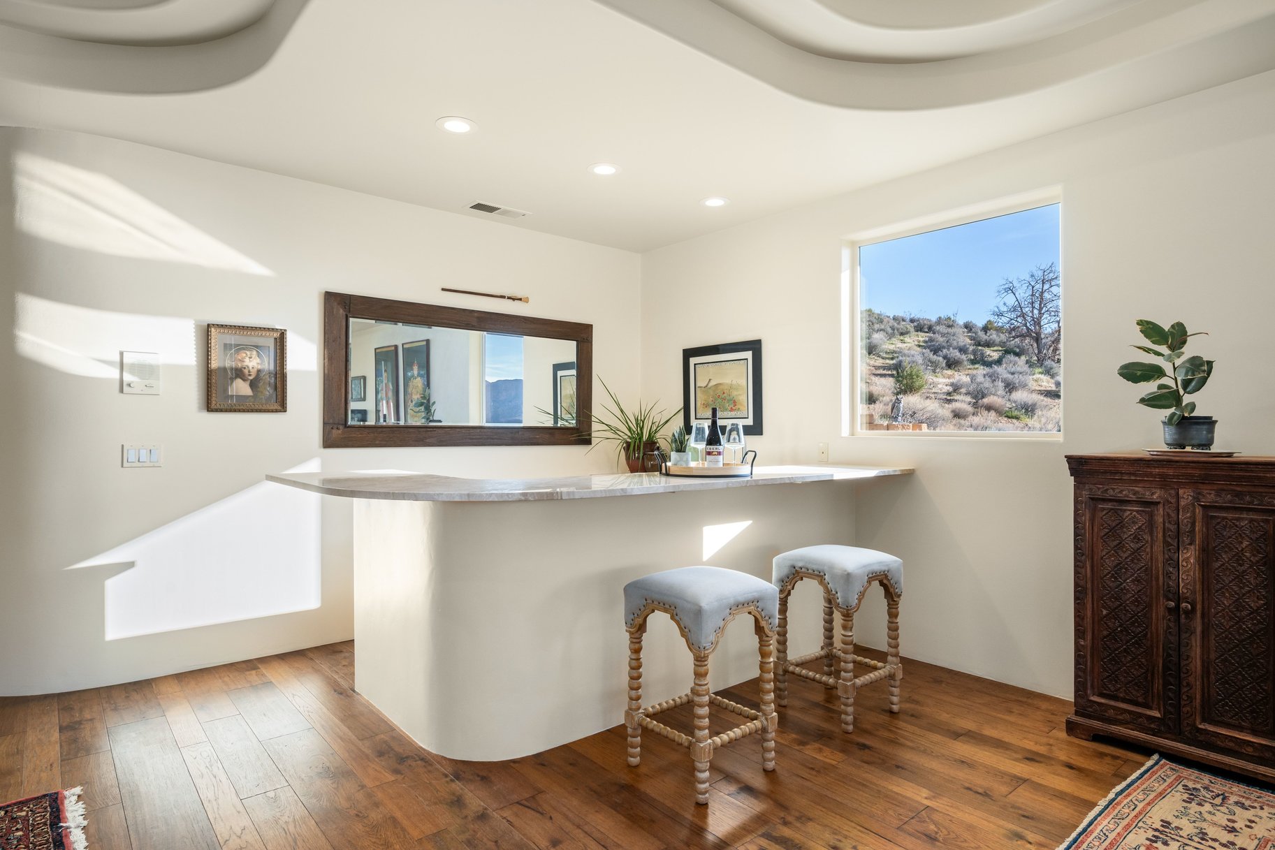 Bar area featuring hardwood / wood-style floors, healthy amount of natural light, recessed lighting, and light stone counters