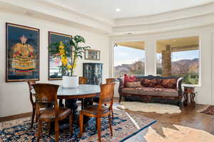 Dining area with wood-type flooring, a mountain view, and recessed lighting