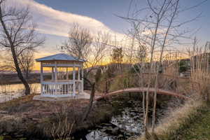 Yard at dusk with a gazebo and a water view