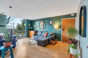 Living room featuring floor to ceiling windows and wood finished floors