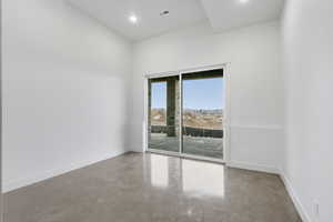 Empty room with concrete floors and recessed lighting
