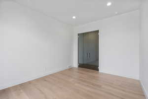 Unfurnished room with light wood finished floors and recessed lighting