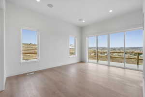 Unfurnished room featuring a mountain view, recessed lighting, and light wood finished floors