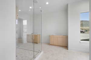 Bathroom featuring a shower stall and recessed lighting