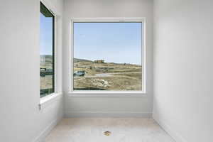 Interior space with baseboards and light tile patterned flooring