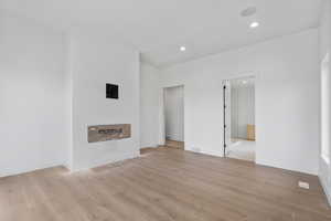 Unfurnished living room featuring light wood-style flooring and recessed lighting