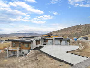 Contemporary house with a mountain view, stone siding, and area for grilling