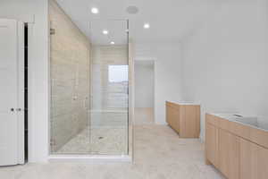 Full bath with vanity, a shower stall, and recessed lighting