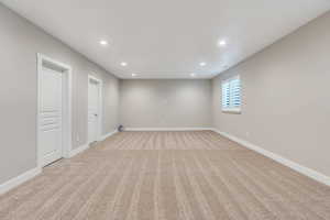 Unfurnished room featuring light colored carpet and recessed lighting