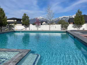 View of pool with a fenced backyard and a mountain view