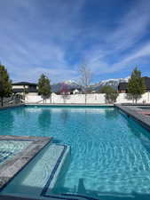 View of pool with a fenced backyard and a mountain view