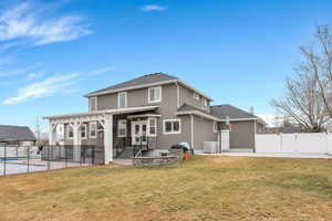 Rear view of property with a fenced backyard, stucco siding, a patio, and a gate