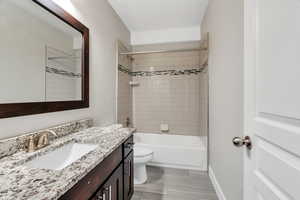 Bathroom with vanity and shower / tub combination