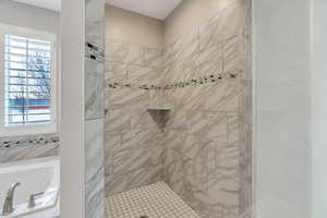 Bathroom featuring a shower stall and a garden tub