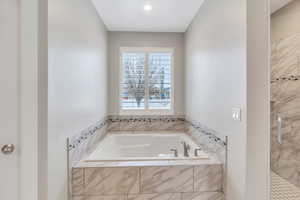 Bathroom with a stall shower and a bath