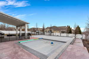 View of pool featuring a residential view and a covered pool