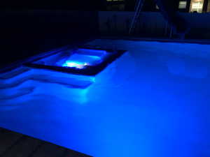 Integrated pool / spa with a water slide