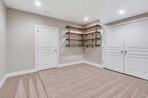 Unfurnished bedroom featuring light carpet and recessed lighting