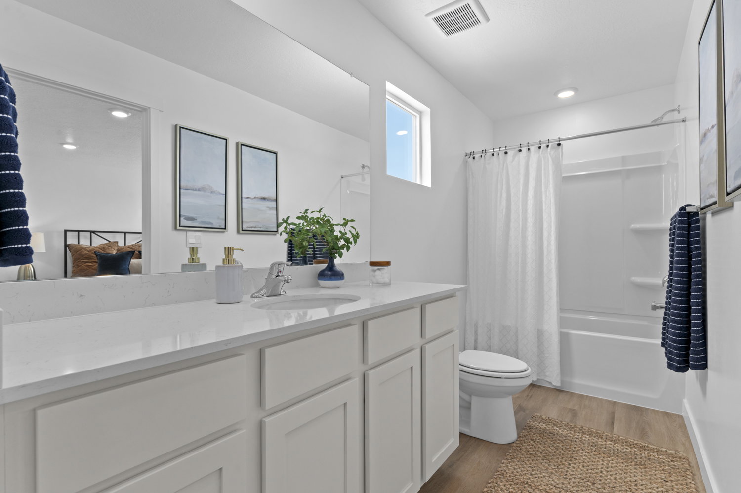 Bathroom with shower / tub combo, vanity, light wood-type flooring, and recessed lighting