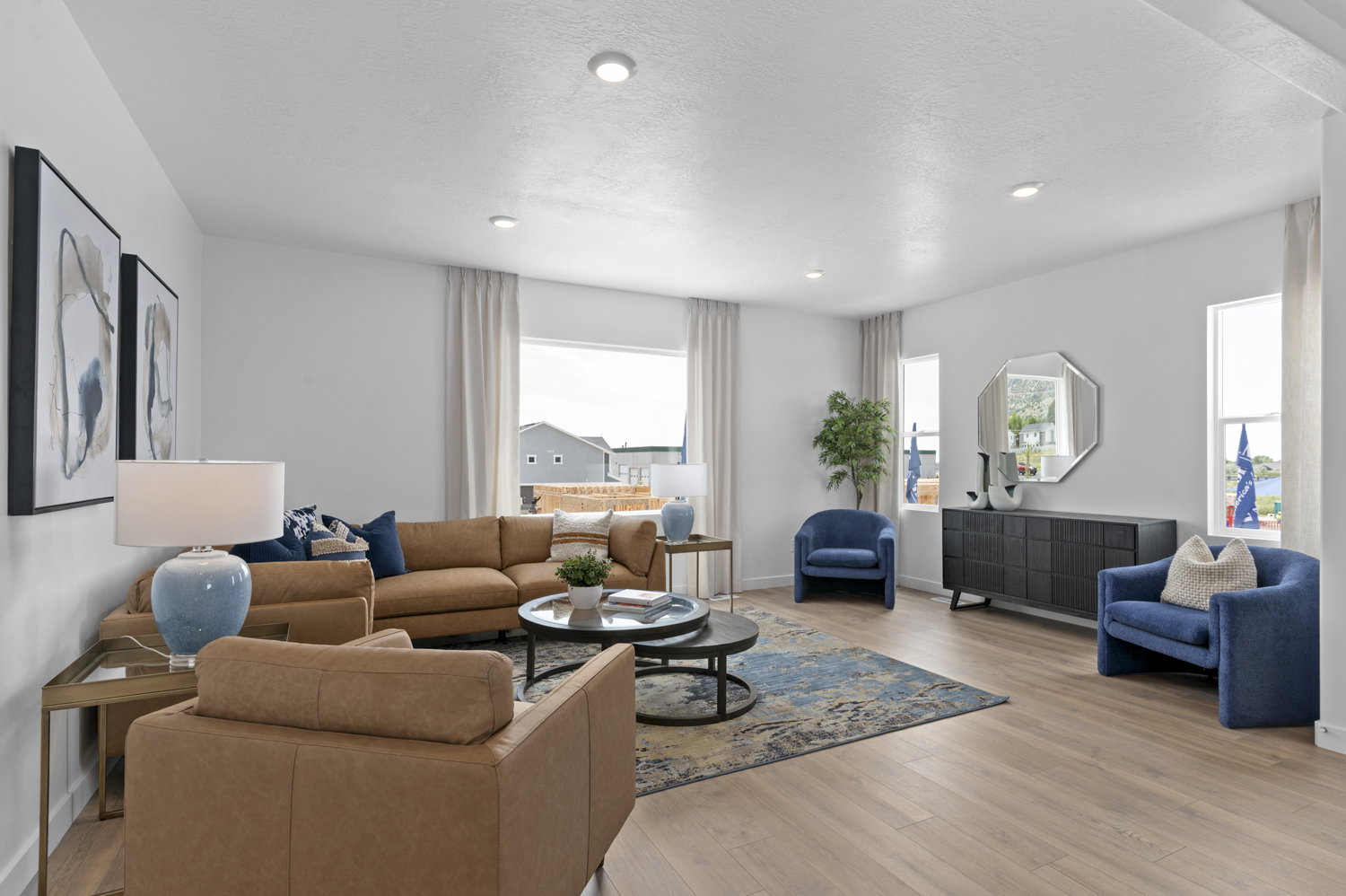 Living area featuring light wood finished floors and recessed lighting