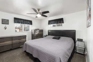 Carpeted bedroom with ceiling fan