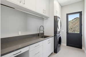 Laundry room with cabinet space and stacked washing machine and dryer