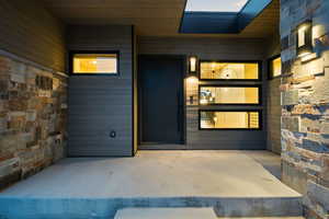 Property entrance with a patio