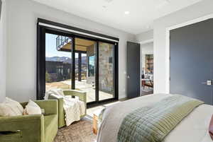 Bedroom featuring access to outside, wood finished floors, a mountain view, and recessed lighting