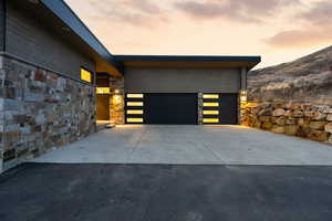 Garage at dusk with concrete driveway