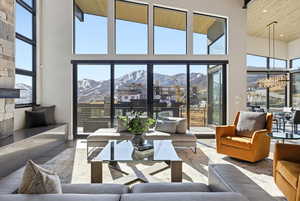 Living room featuring a mountain view, wood finished floors, a high wooden ceiling, and recessed lighting