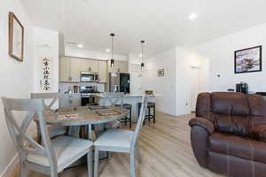 Dining space featuring light wood-style flooring and recessed lighting