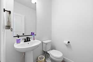 Bathroom featuring toilet and baseboards