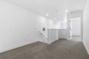 Empty room featuring carpet floors and recessed lighting