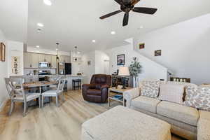 Living room featuring light wood-style floors, ceiling fan, and recessed lighting