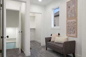 Living area with dark carpet and baseboards