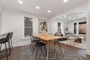 Dining area featuring hardwood / wood-style flooring, arched walkways, and recessed lighting