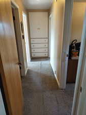 Corridor with carpet and baseboards