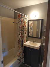 Full bath featuring vanity and shower / bath combo with shower curtain